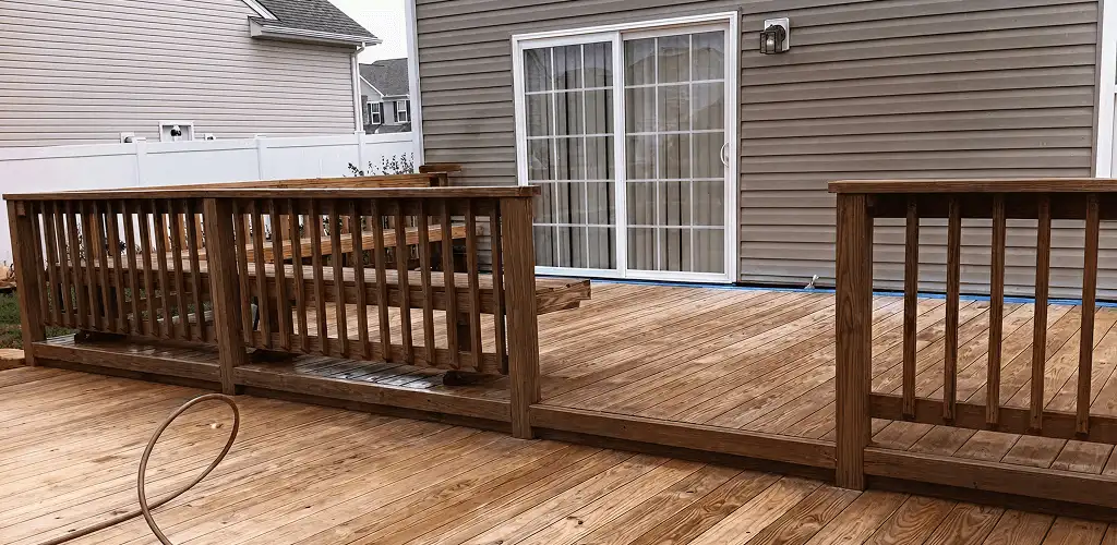 Deck sealing service protecting a backyard wood deck and railings in Columbia, MO
