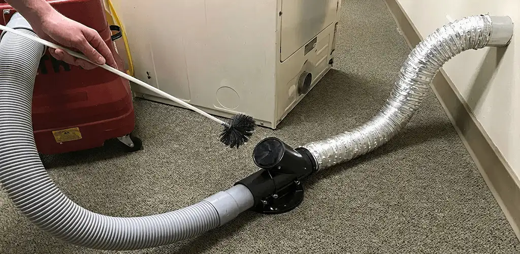 Dryer vent cleaning service removing lint from a dryer duct connection in Columbia, MO