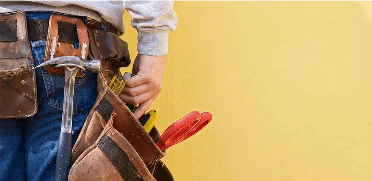 Handyman with tool belt ready for home repairs and maintenance in Columbia, MO