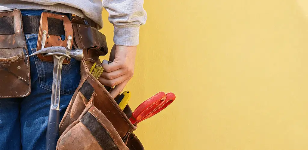 Handyman with tool belt ready for home repairs and maintenance in Columbia, MO