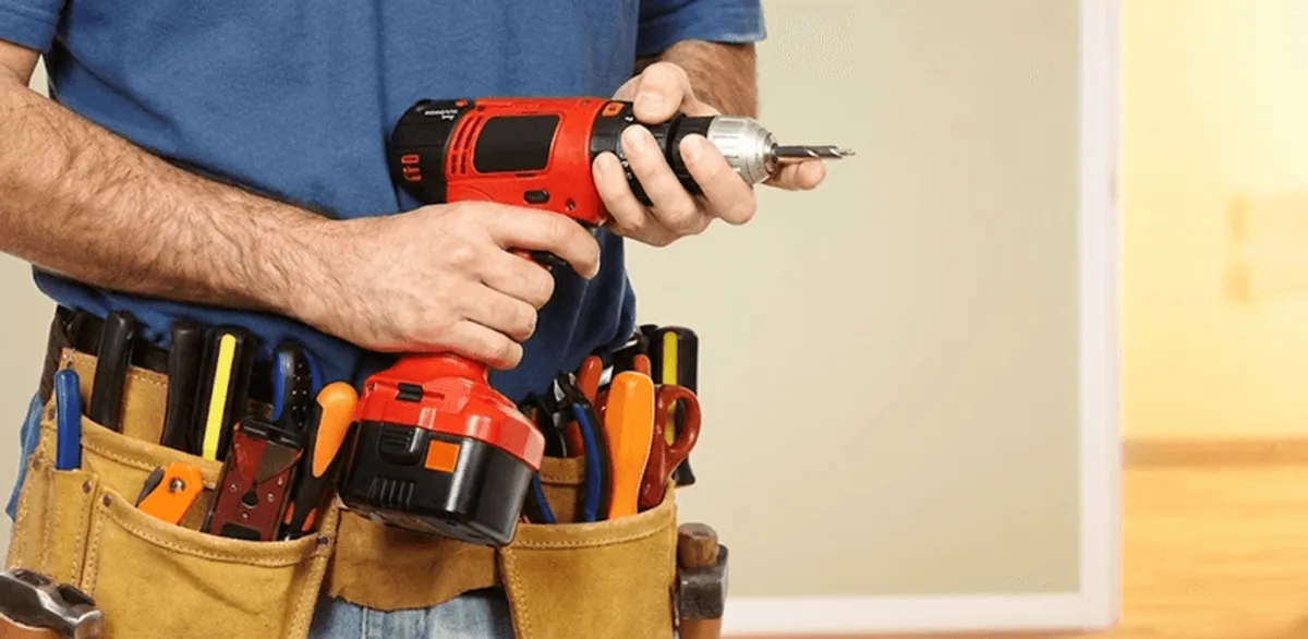 Handyman holding a power drill for home repairs and installations in Columbia, MO