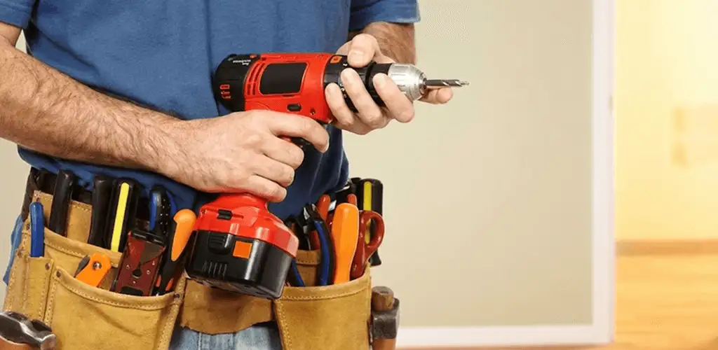 Handyman holding a power drill for home repairs and installations in Columbia, MO