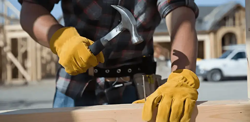 Handyman fixing wood trim with a hammer for home repairs in Columbia, MO